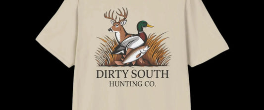 Beige t-shirt with a graphic of a deer and duck and 'Dirty South Hunting Co.' text on a white background